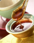 Maggie Gin's Sweet & Sour Sauce in a small bowl with spoon.